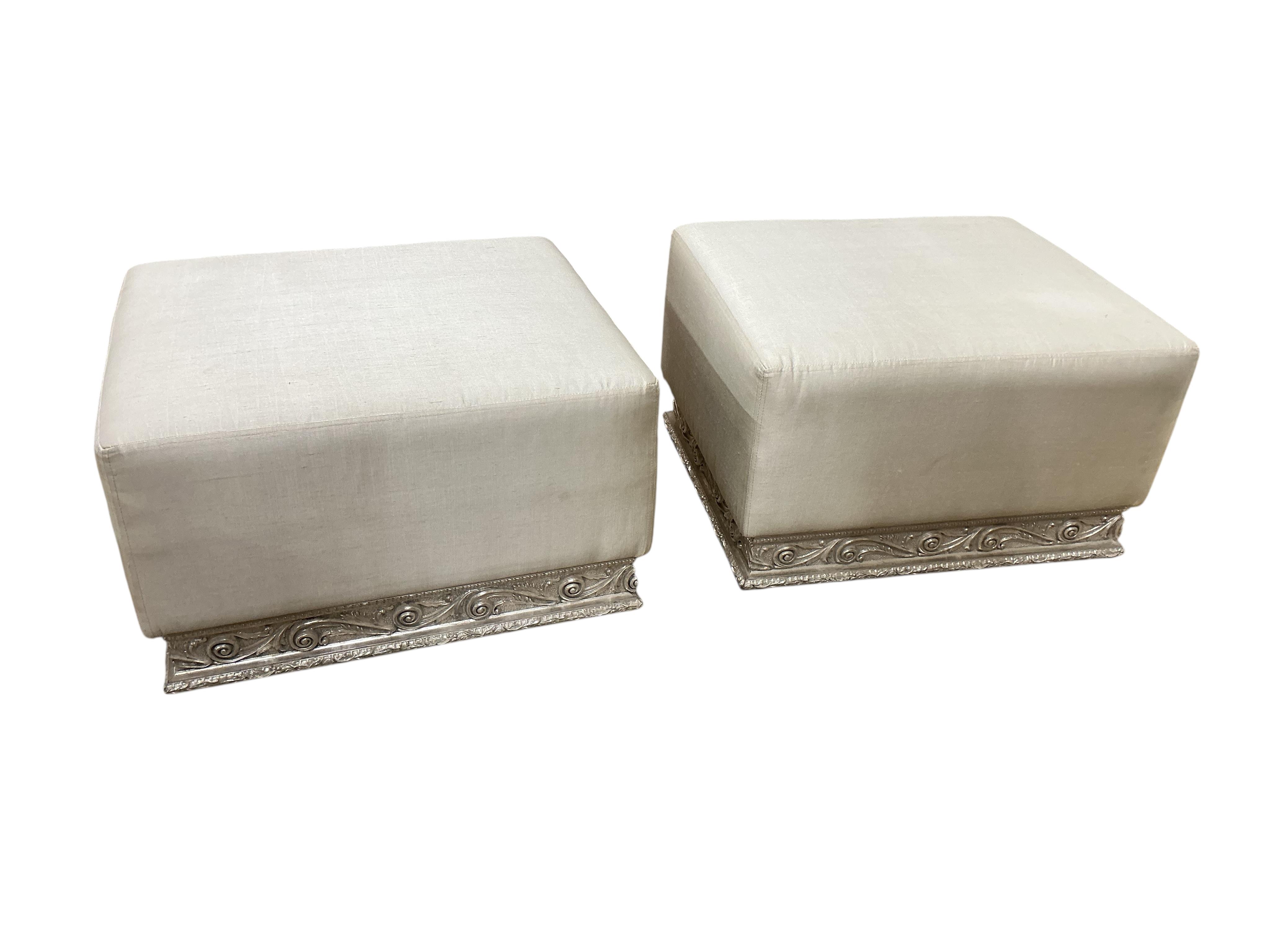 A pair of contemporary ivory fabric and silvered wood stools, width 70cm, depth 60cm, height 44cm